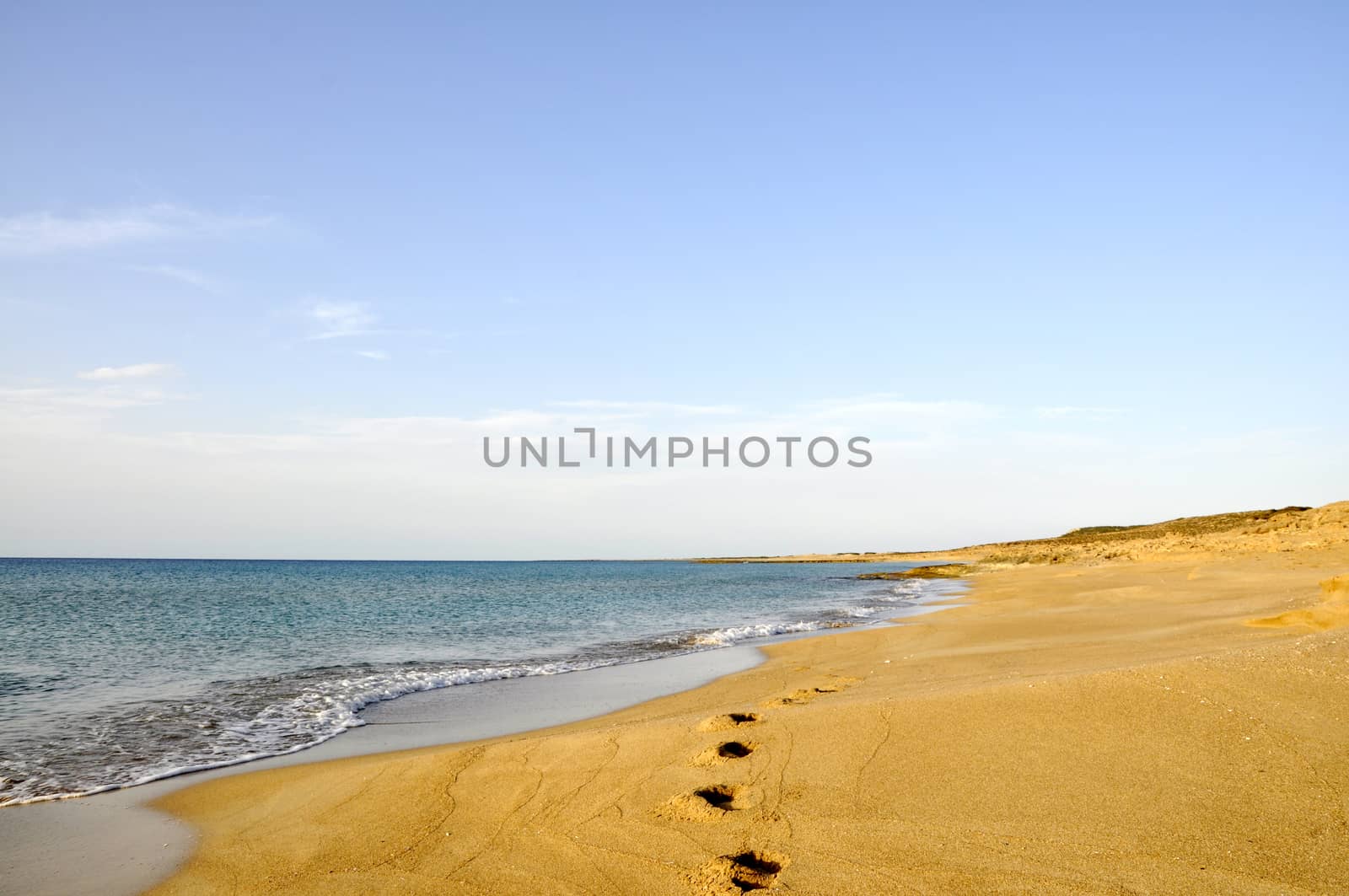 Footprints on sand beach in the morning during summer vacation in Cyprus