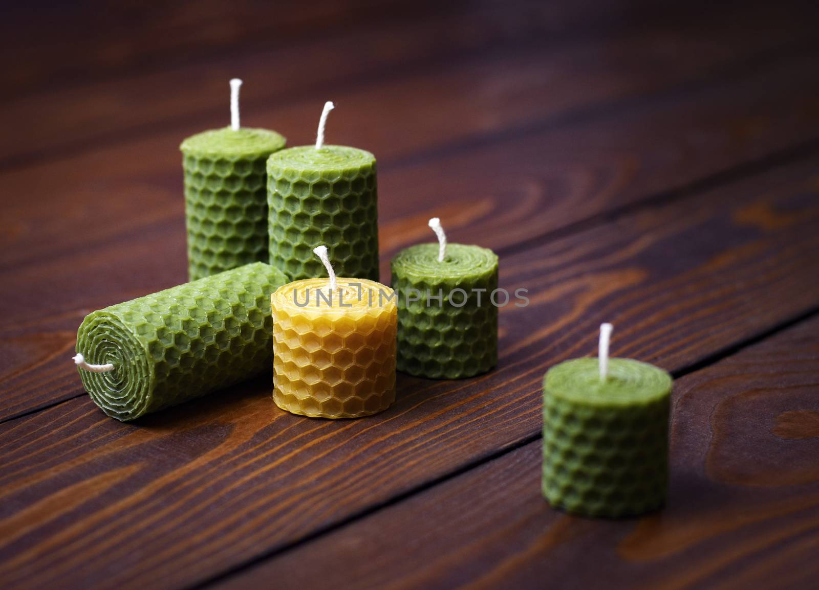 beeswax candles on a dark wooden table by Ahojdoma