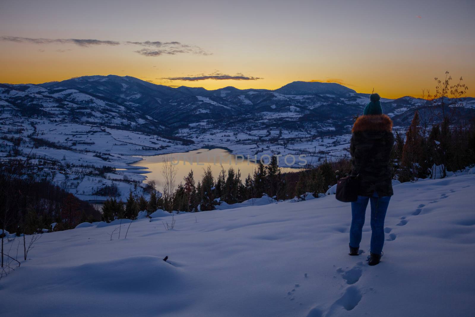 Photographers photographing winter lake mountain scene in sunset by adamr