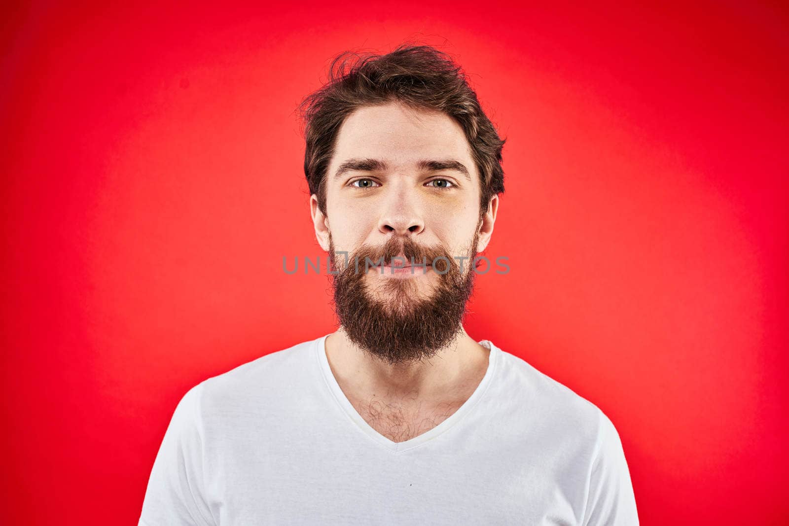 Bearded man fun emotions lifestyle cropped view white t-shirt red background by SHOTPRIME
