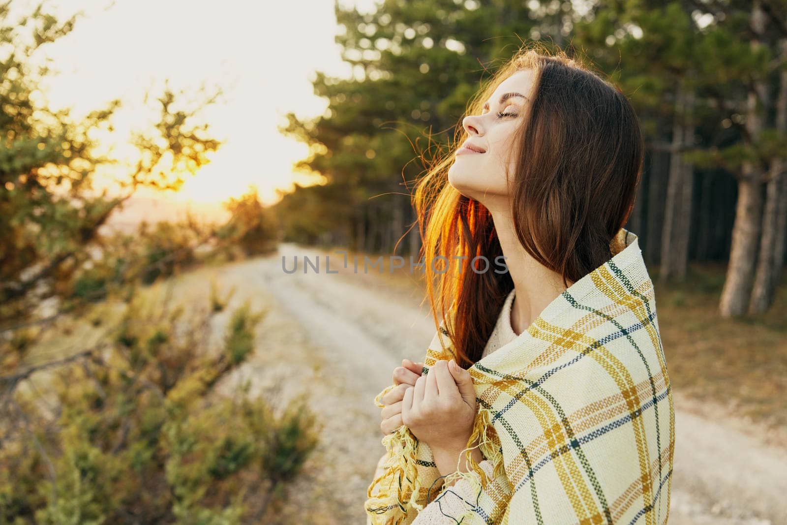 woman with closed eyes in plaid blanket fresh air nature enjoyment by SHOTPRIME