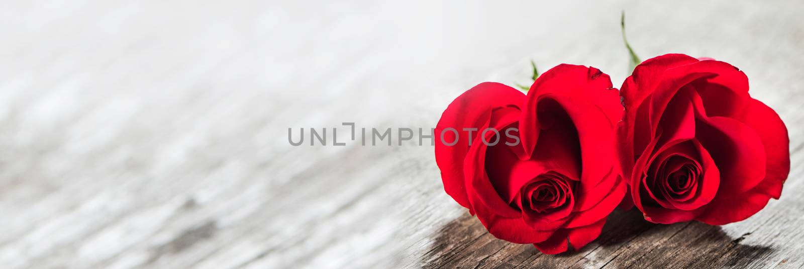 Hearts of red roses on wooden background Valentines day design
