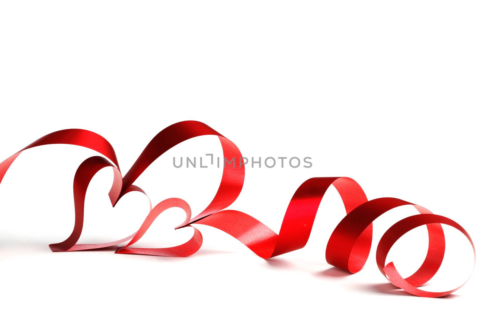 Heart shaped red ribbon isolated on white background