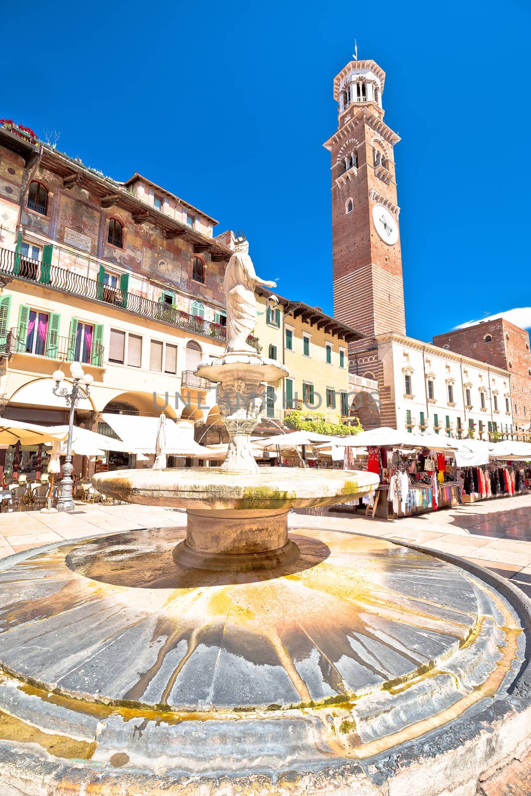 Piazza delle erbe in Verona street and market view with Lamberti tower, tourist destination in Veneto region of Italy
