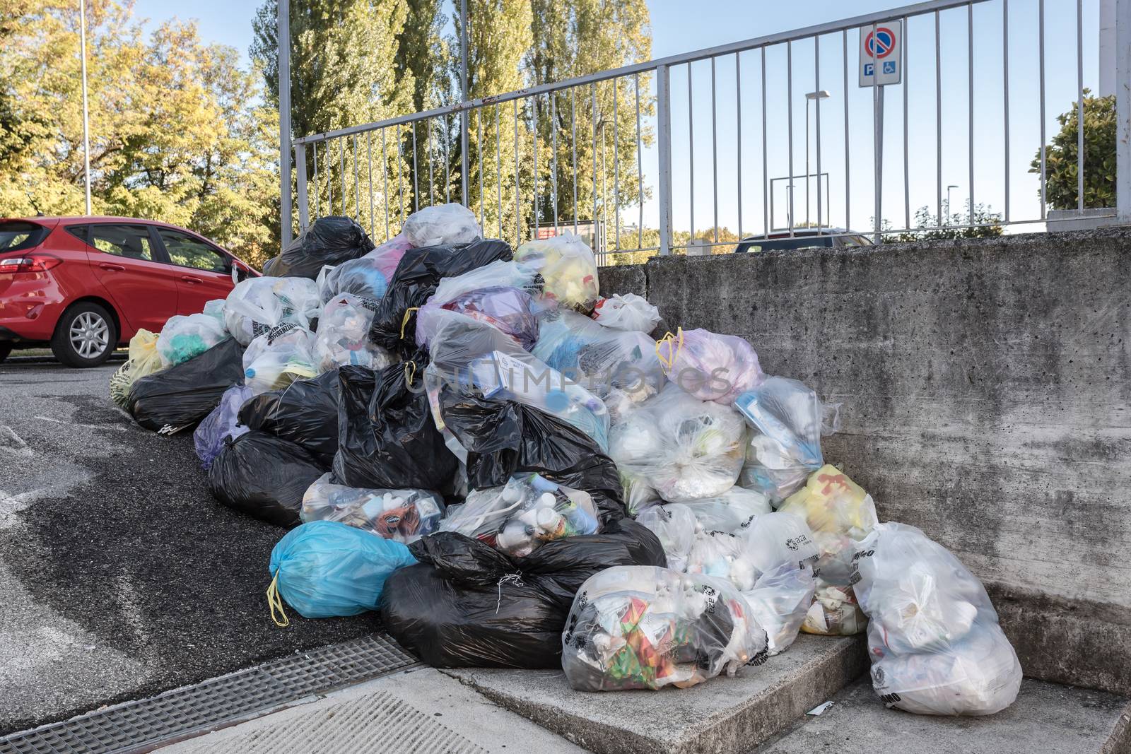 Road and footpath full of garbage / Dirty street. Bergamo, ITALY - October 12, 2020.