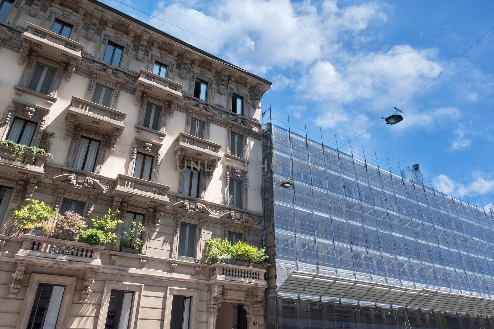 Scaffolding on a historic Italian palace, building under renovation.