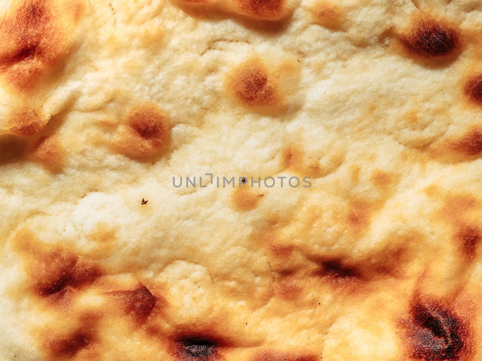 Naan bread texture. Fresh naan flat-bread texture as background or wallpaper. Copy space.