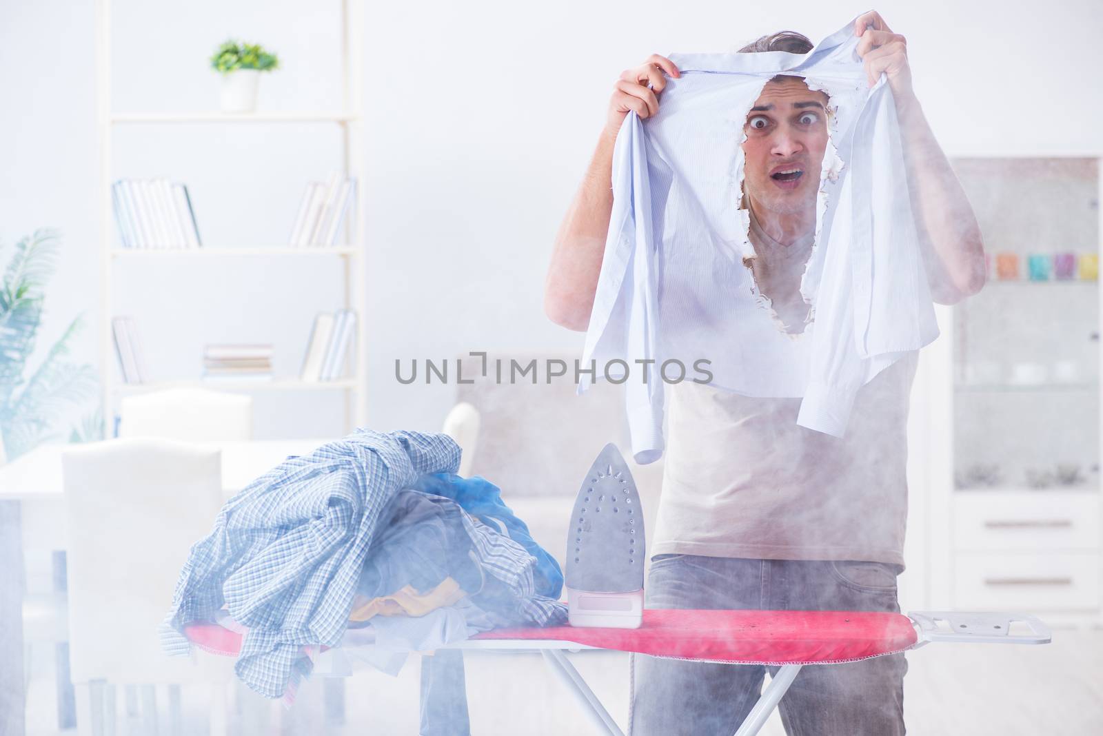 Inattentive husband burning clothing while ironing