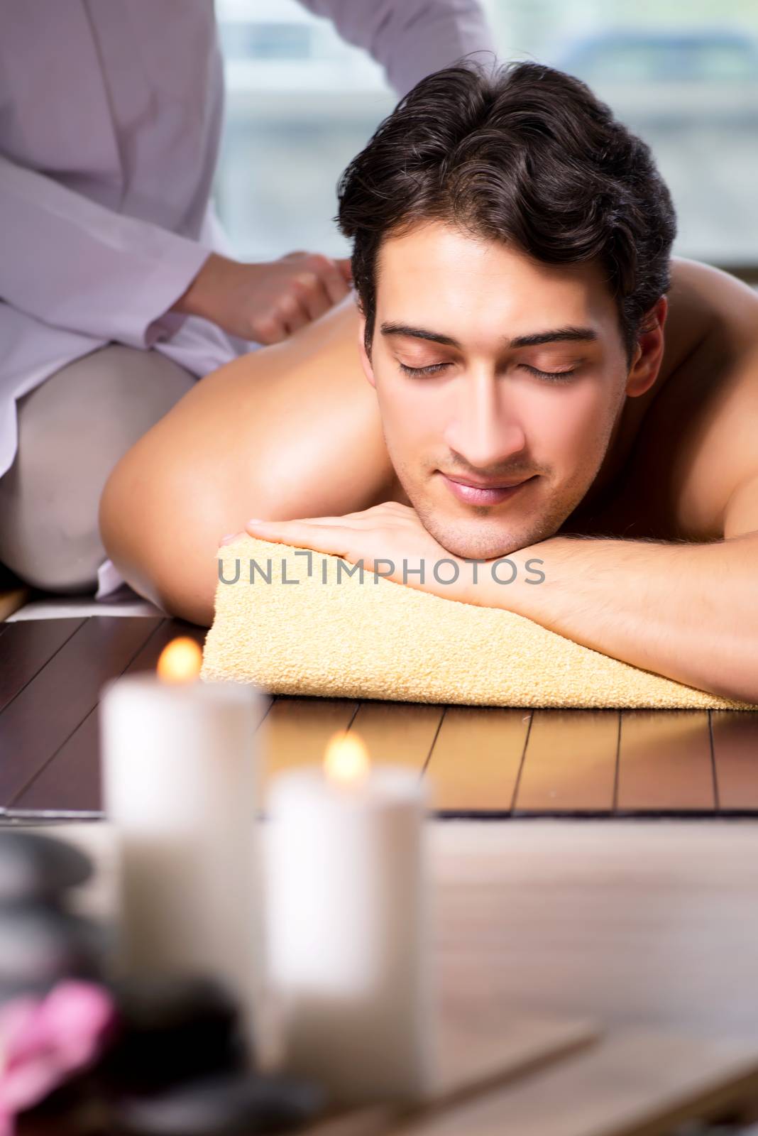 Young handsome man during spa procedure