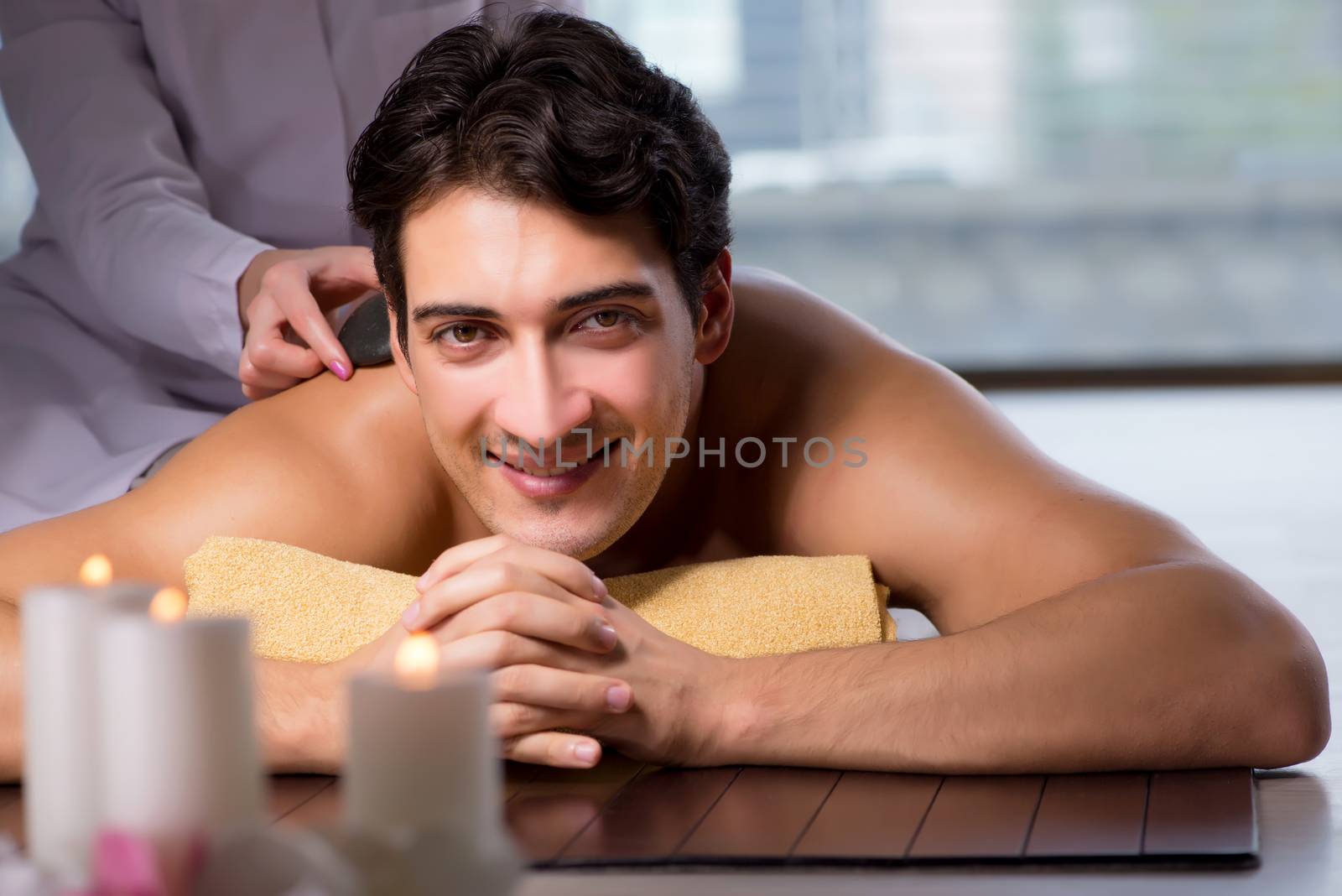 Young handsome man during spa procedure