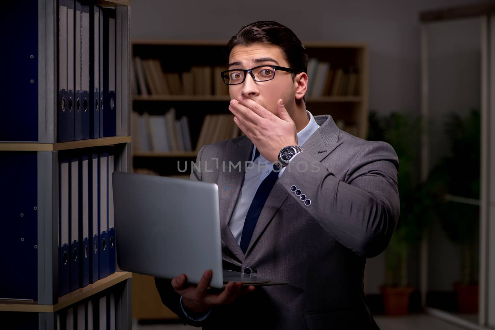 Businessman working late hours in the office