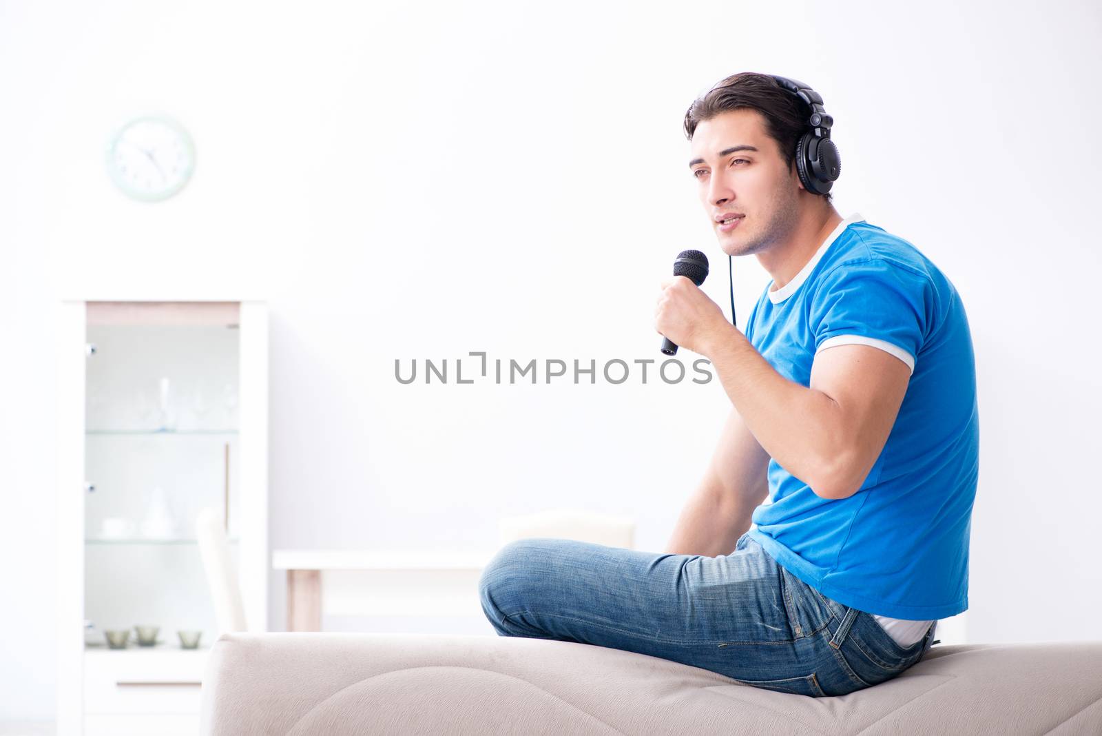 Young man singing at home karaoke
