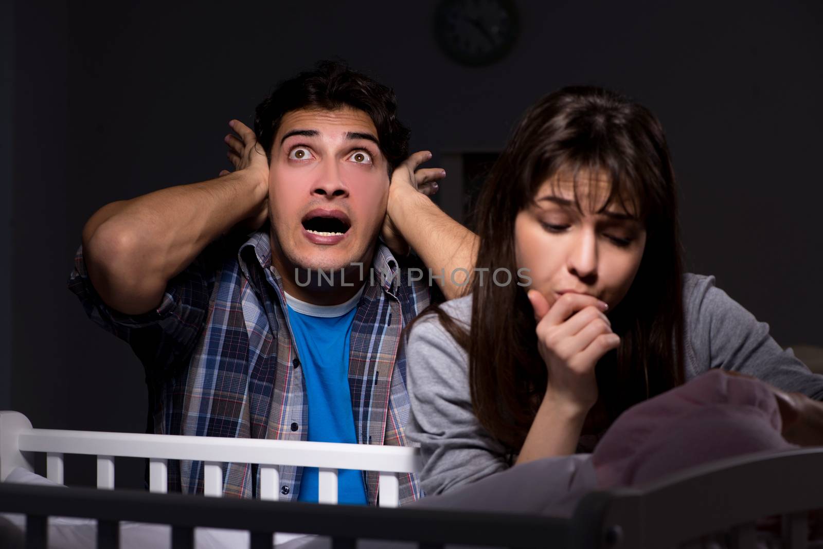 Young parents sleepless with newborn baby at night