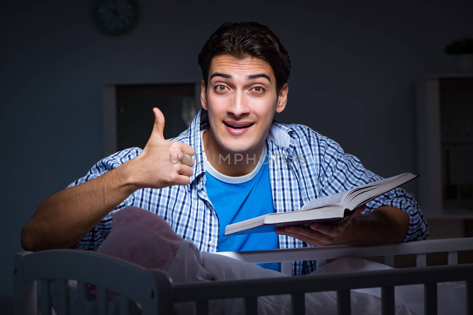 Young student doing homework and looking after newborn baby