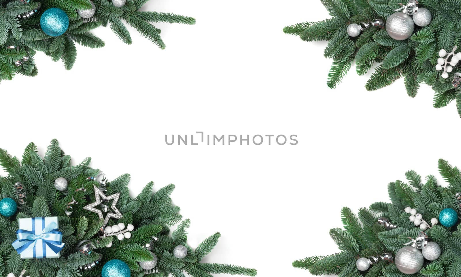 Christmas design element of noble fir tree branches and silver baubles isolated on white background