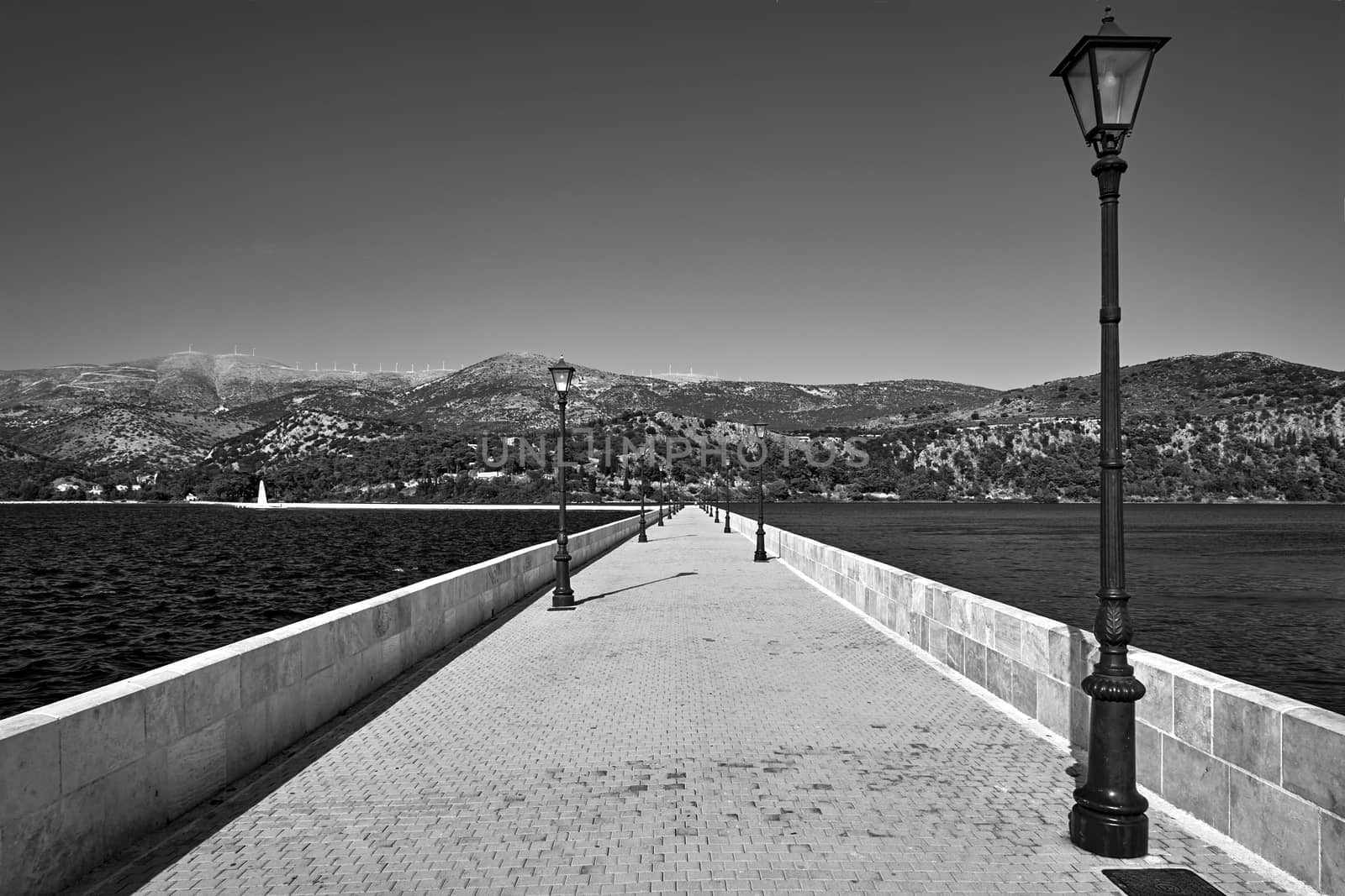 A stone bridge over the bay in the town of Argostoli on the island of Crete in Greece, monochrome