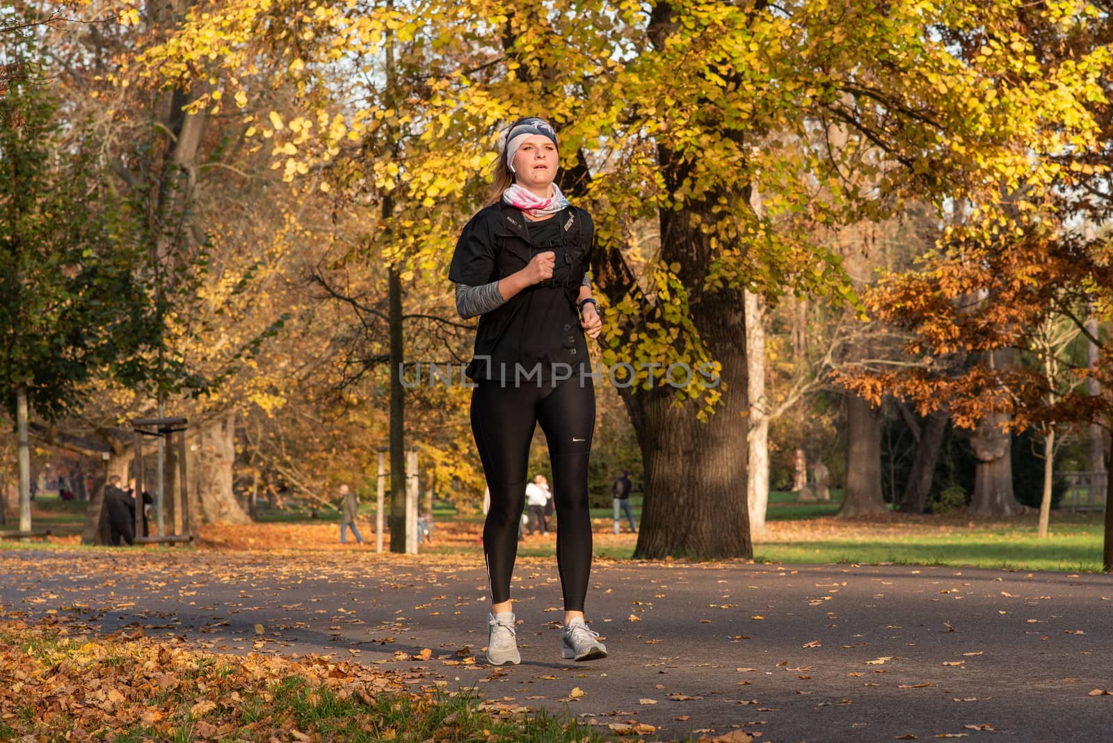 11/14/2020. Park Stromovka. Prague czech Republic. A woman is running in the park on a Sunday winter day.