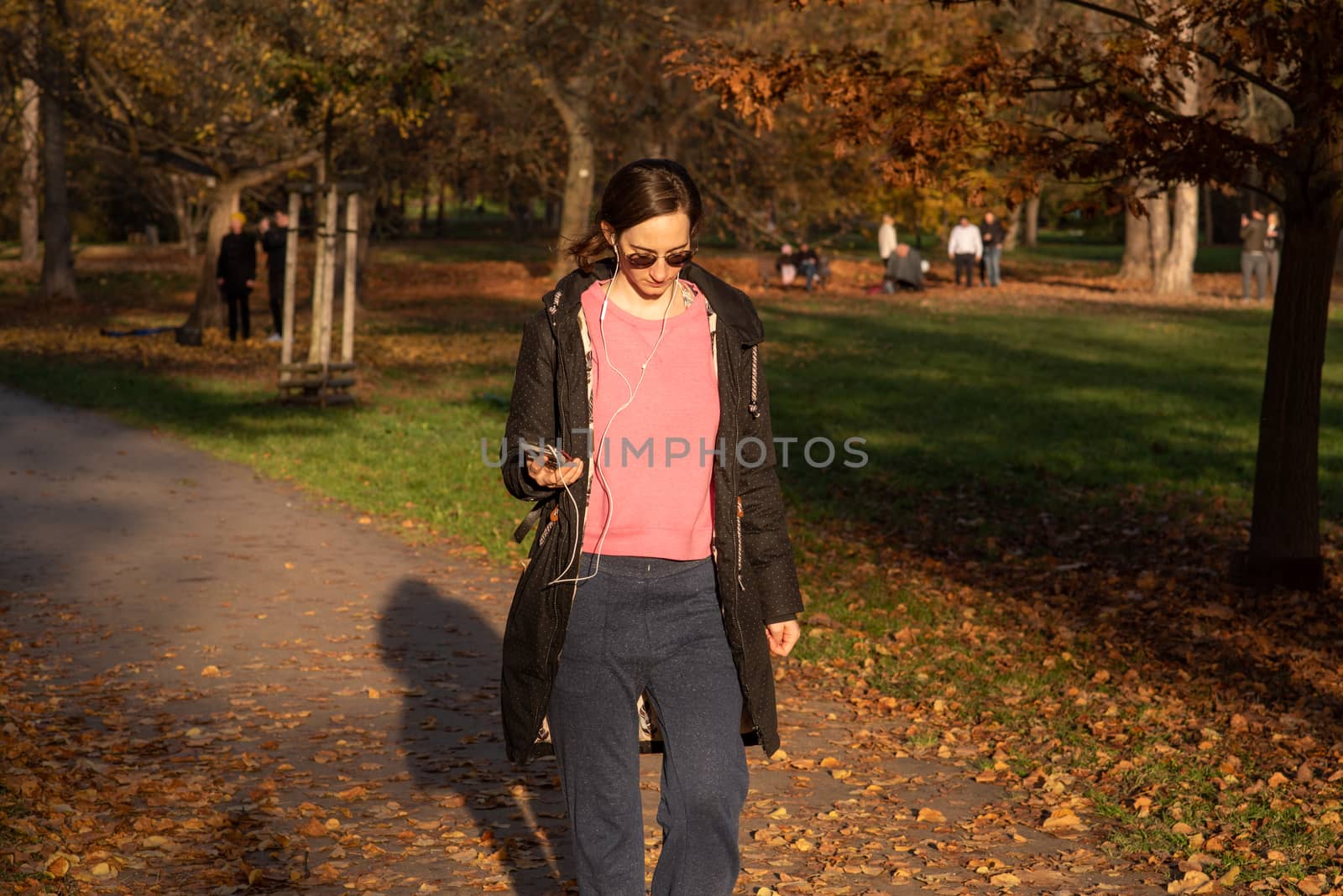 11/14/2020. Park Stromovka. Prague czech Republic. A woman is walking in the park on a Sunday winter day. by gonzalobell