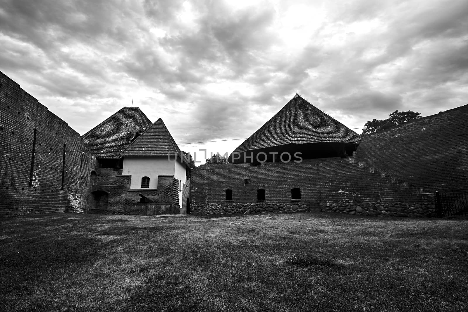 Ruins of walls of a medieval defensive castle in the city of Miedzyrzecz in Poland, monochrome