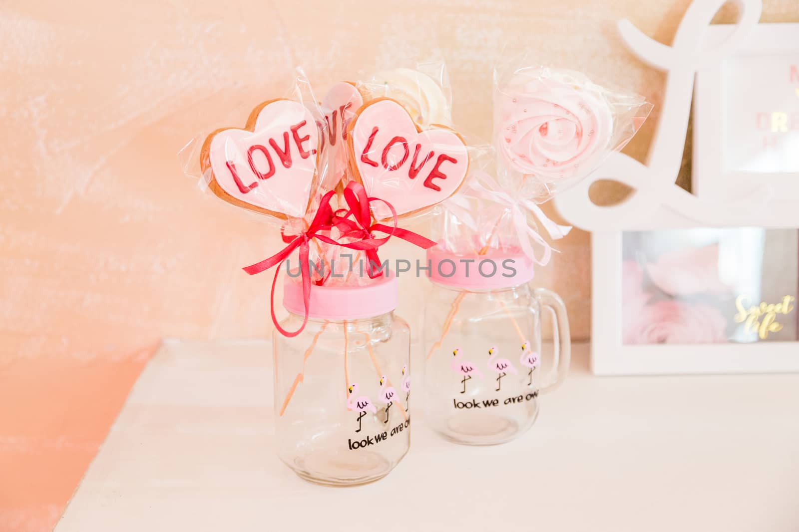 Sweets on a stick in a transparent glass jar valentine's day decoration.