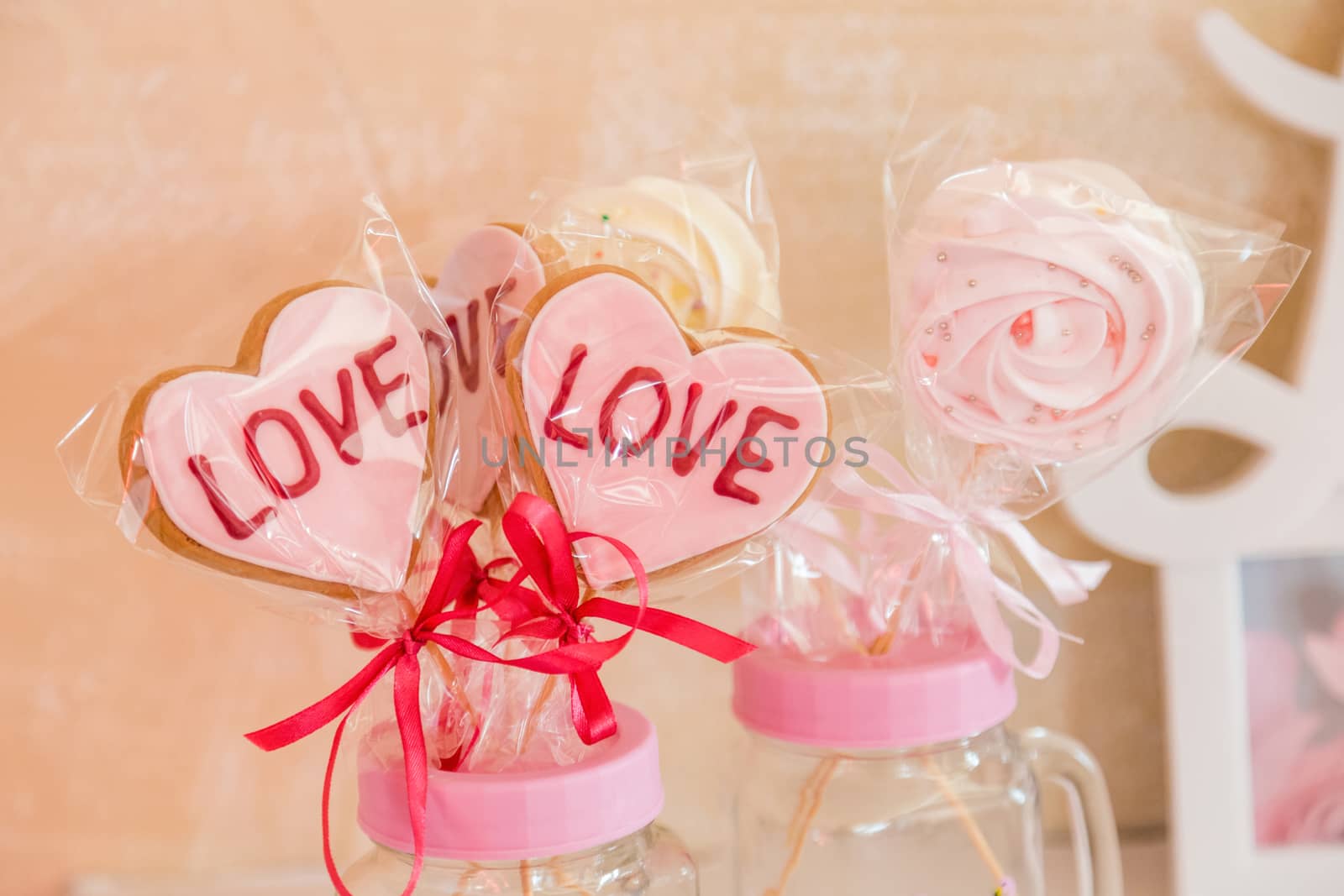 Sweets on a stick in a transparent glass jar valentine's day decoration by galinasharapova