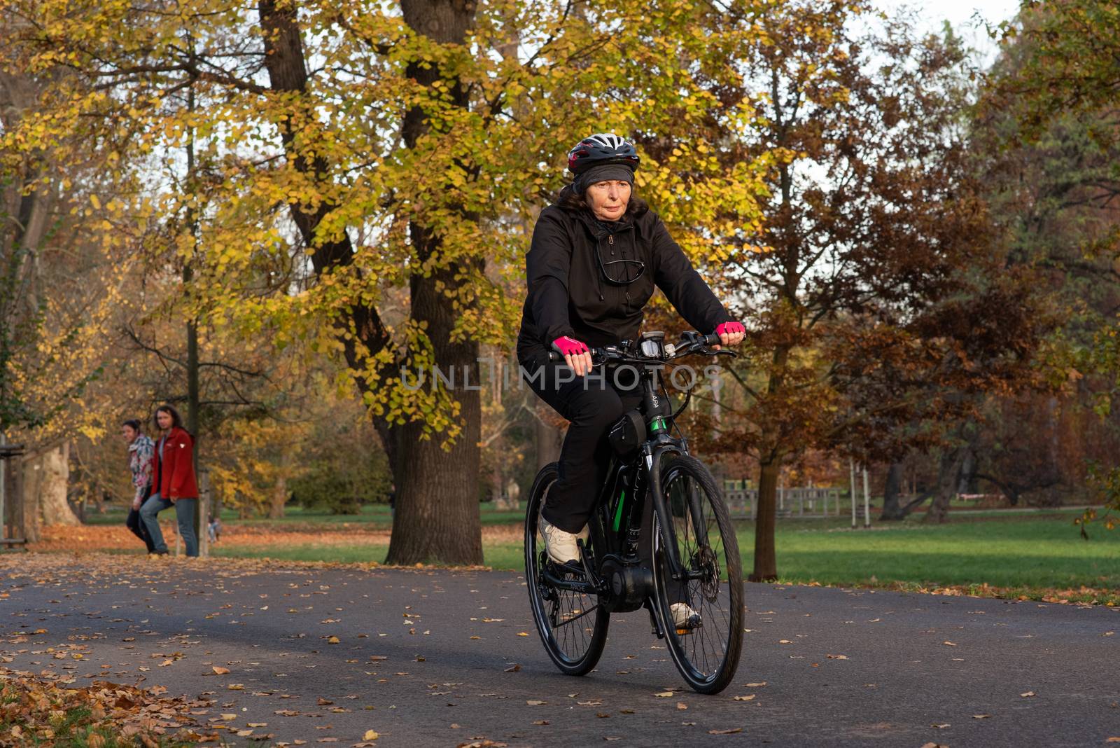 11/14/2020. Park Stromovka. Prague. Czech Republic. A woman is riding his bike at the park on a winter day. by gonzalobell