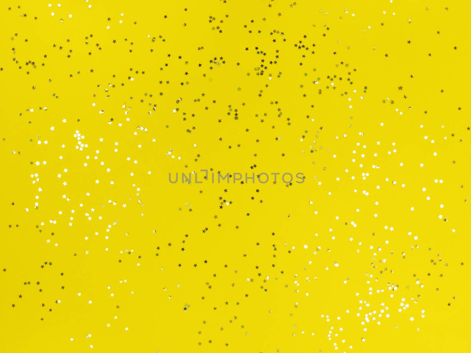 Confetti stars sparkling on yellow background.