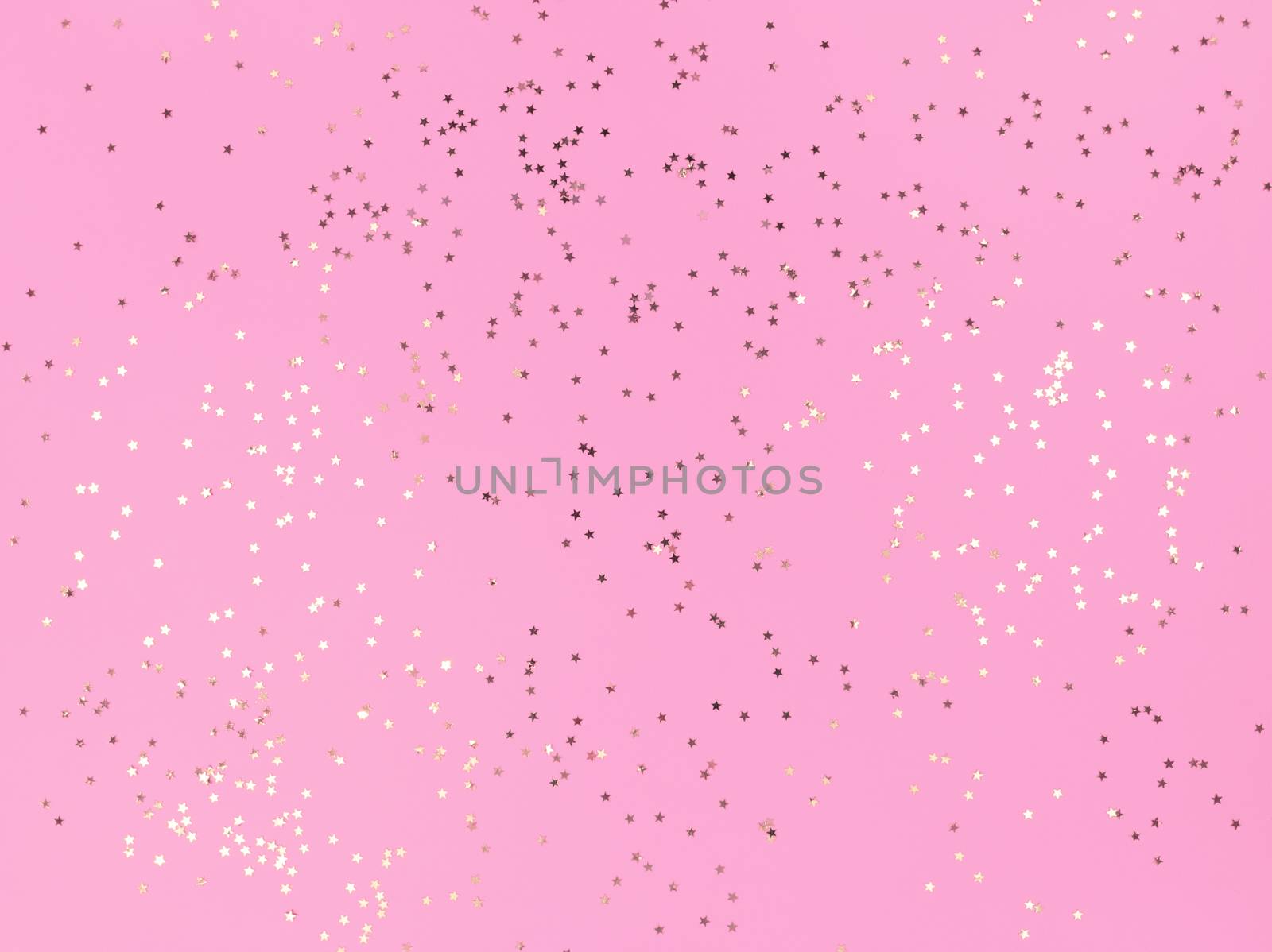 Confetti stars sparkling on pink background.