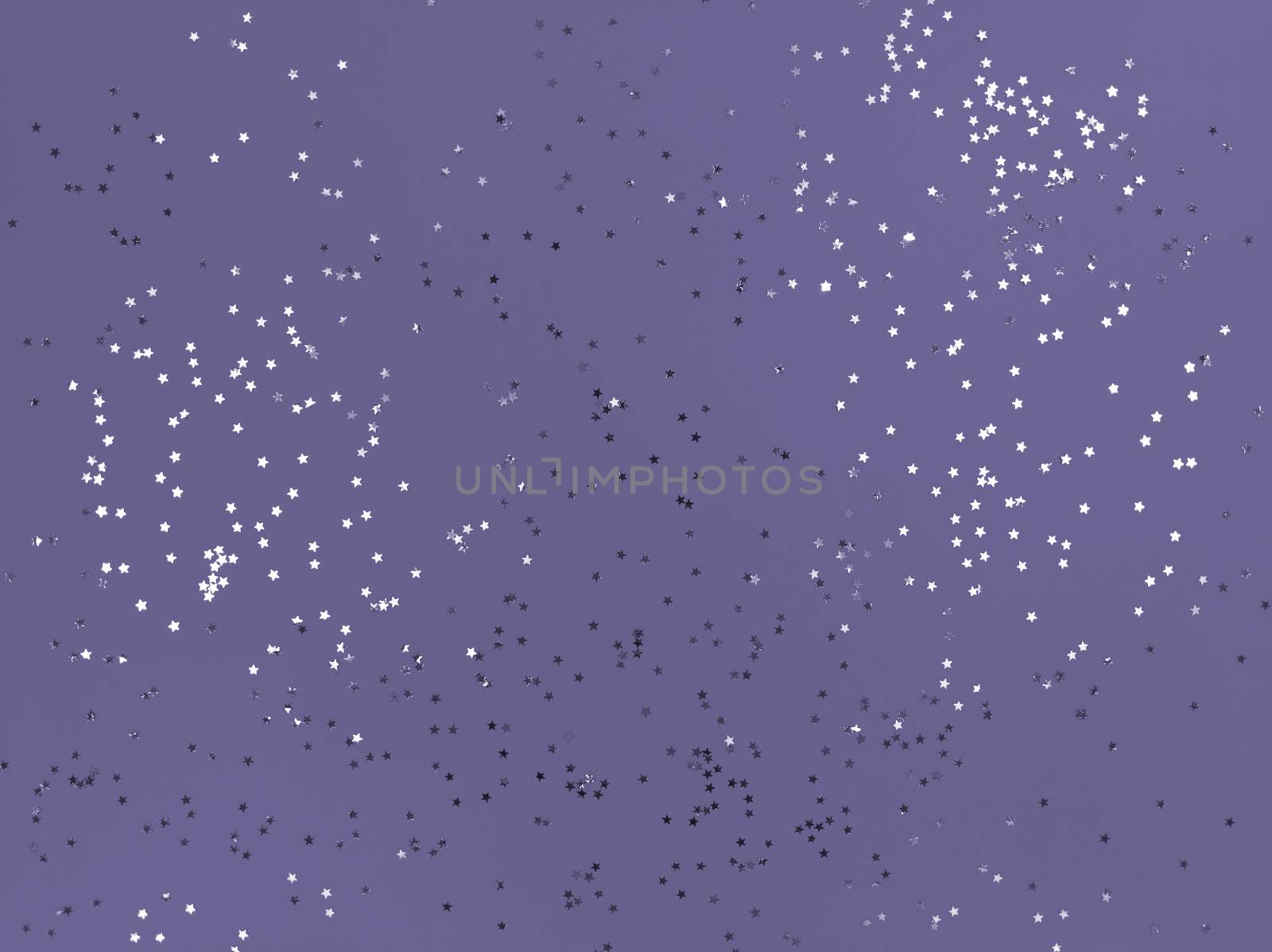 Confetti stars sparkling on lavender color background