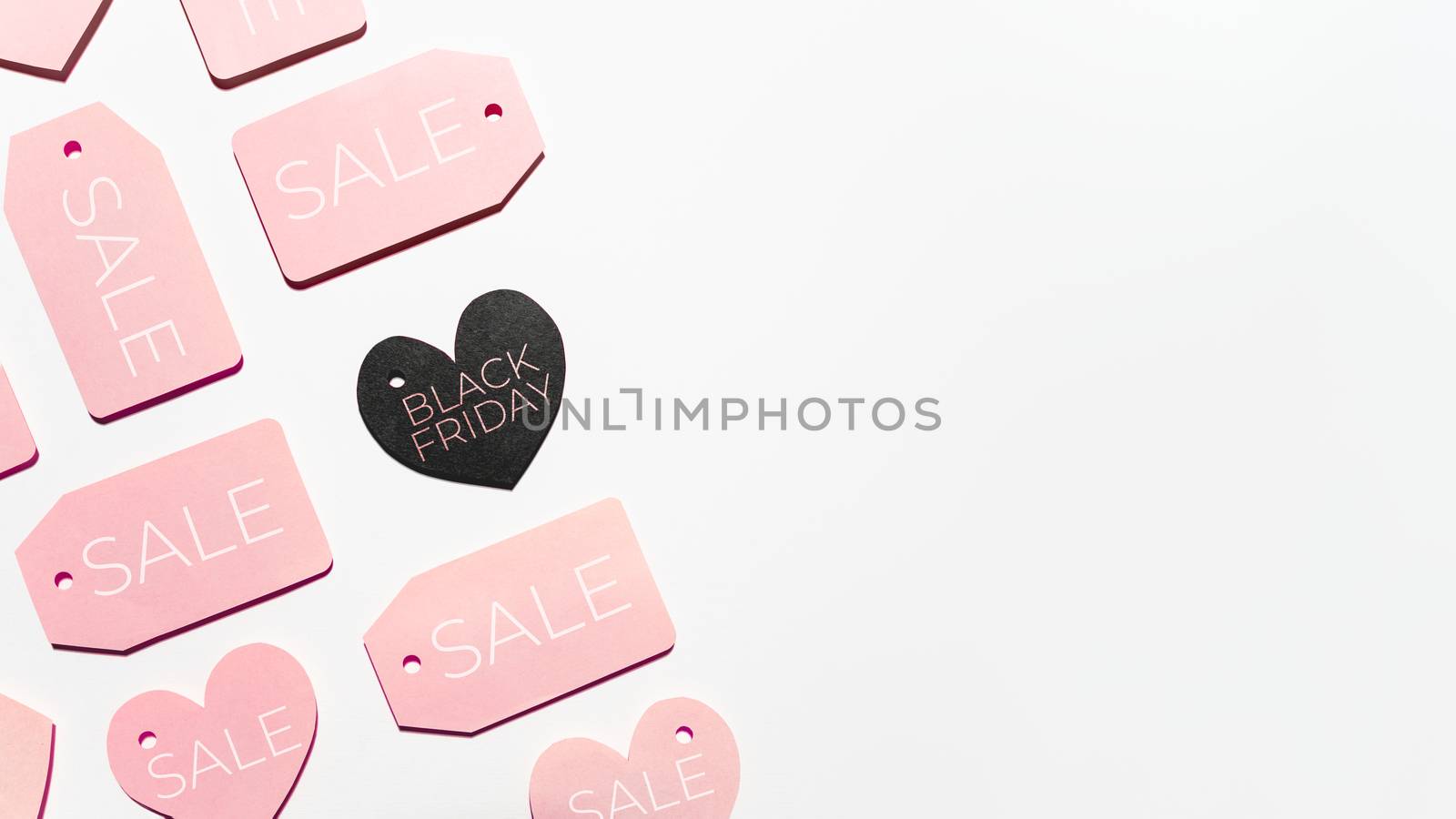 Top view on pattern of pink and black clothes tags in shape of h by aksenovko