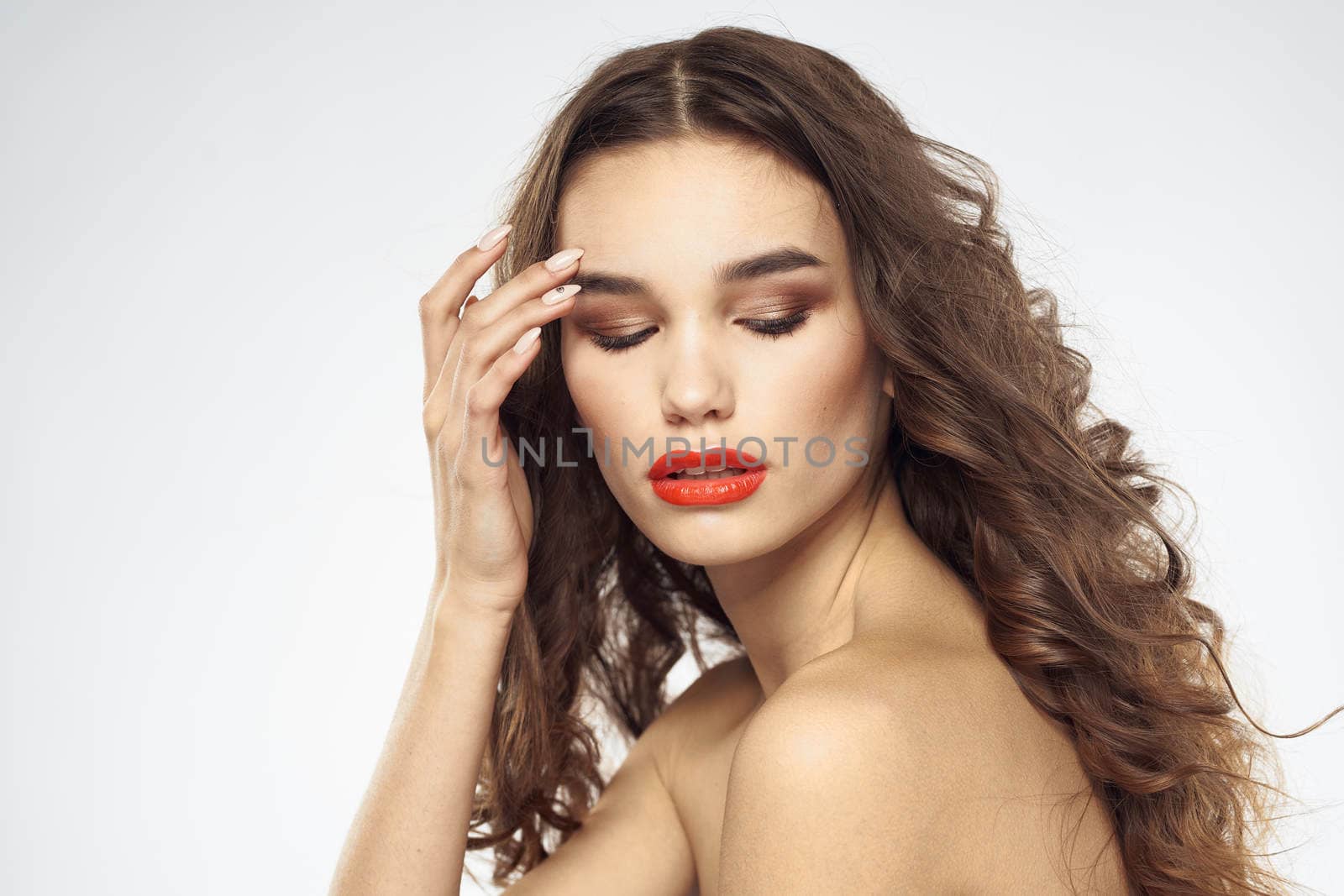 Beautiful woman with drawn swords bright makeup glamor close-up light background. High quality photo