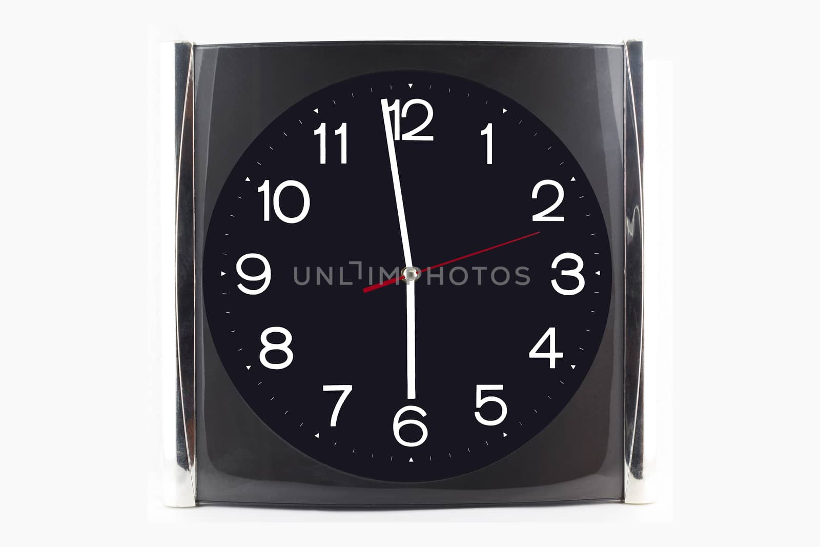 Clock black-grey stainless on the wall and table isolated on whi by jayzynism