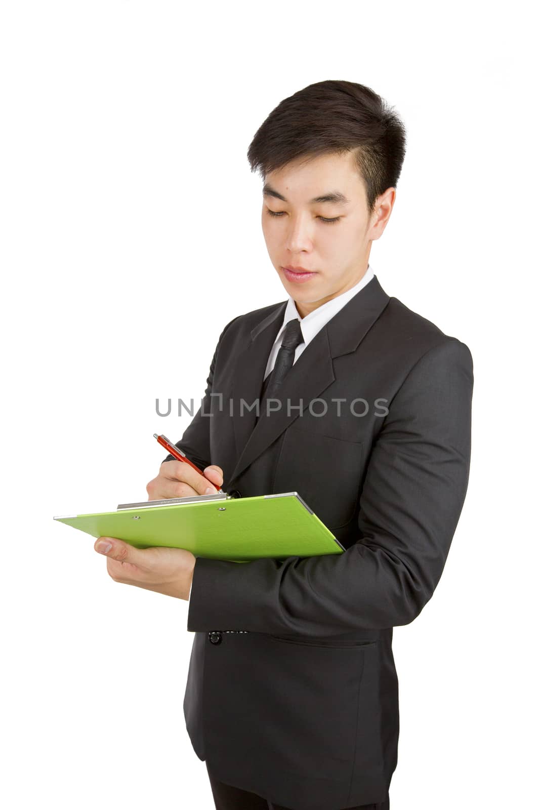 Young Businessman writing note and lecture on green clipboard against a white background.