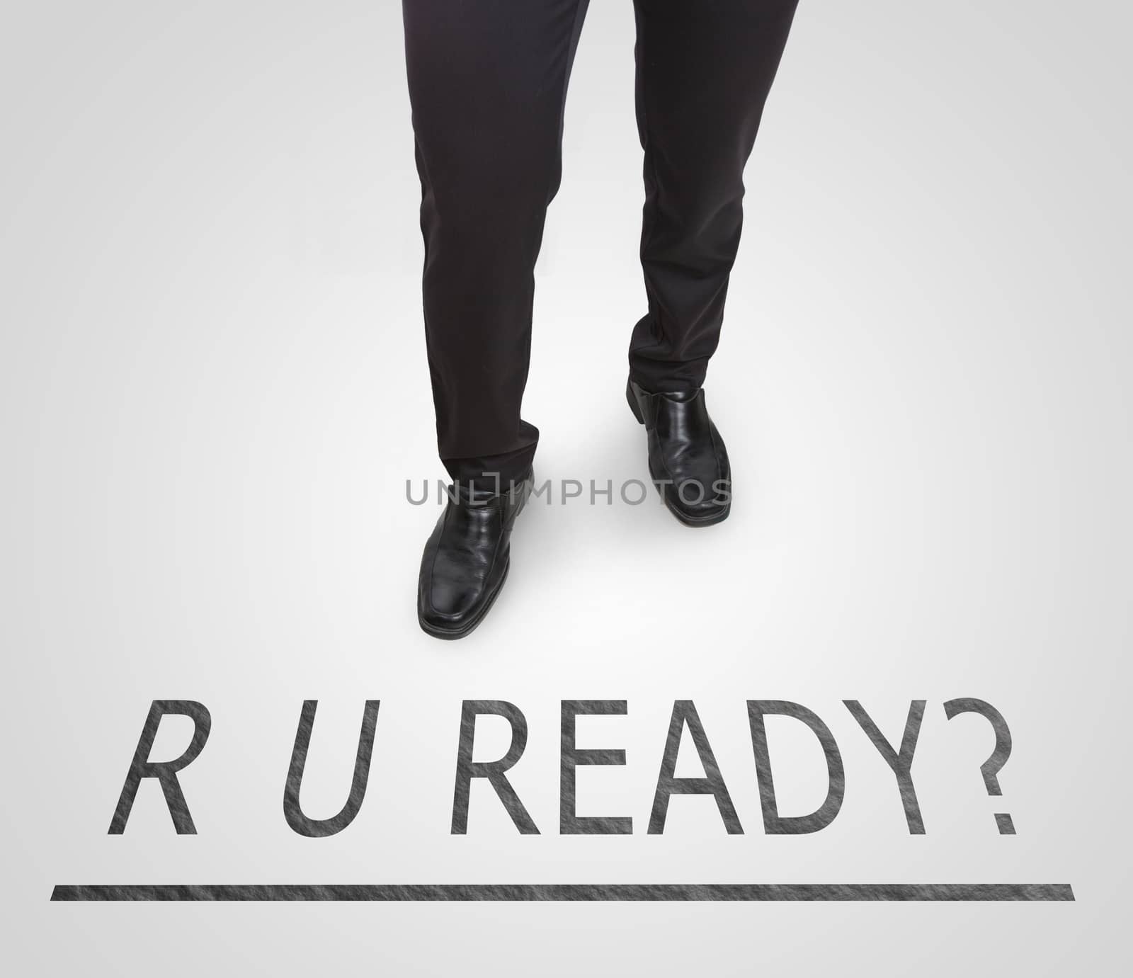 Businessman standing wearing court shoes on ready line.