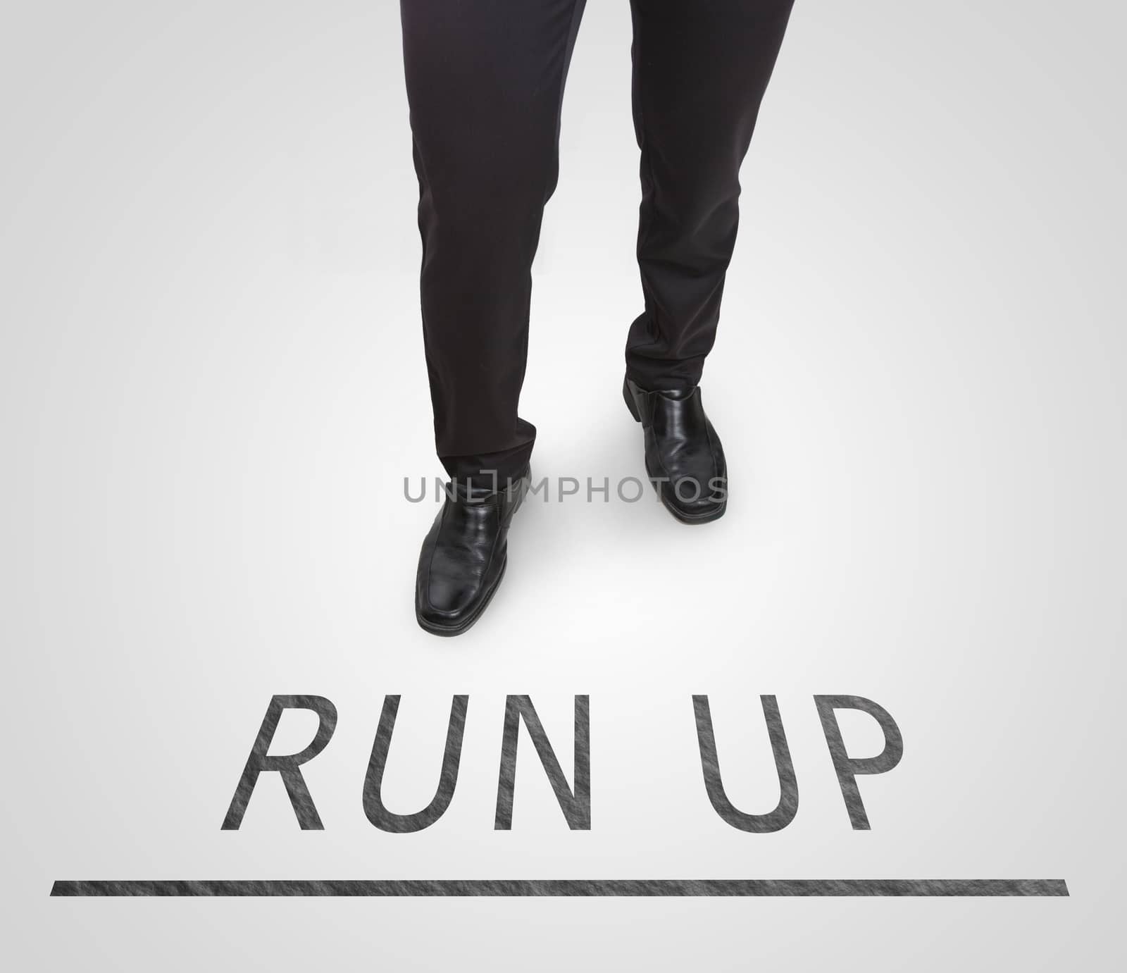 Businessman standing wearing court shoes on run up line. by jayzynism