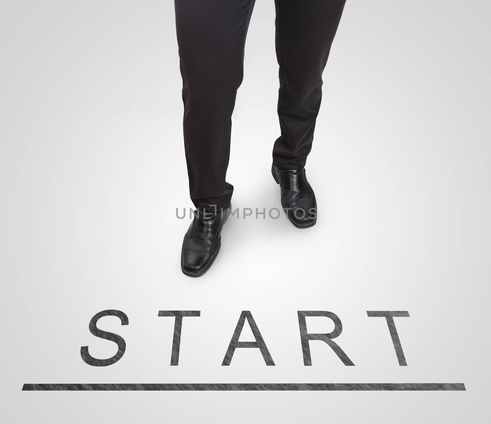 Businessman standing wearing court shoes on start(begin) line. by jayzynism