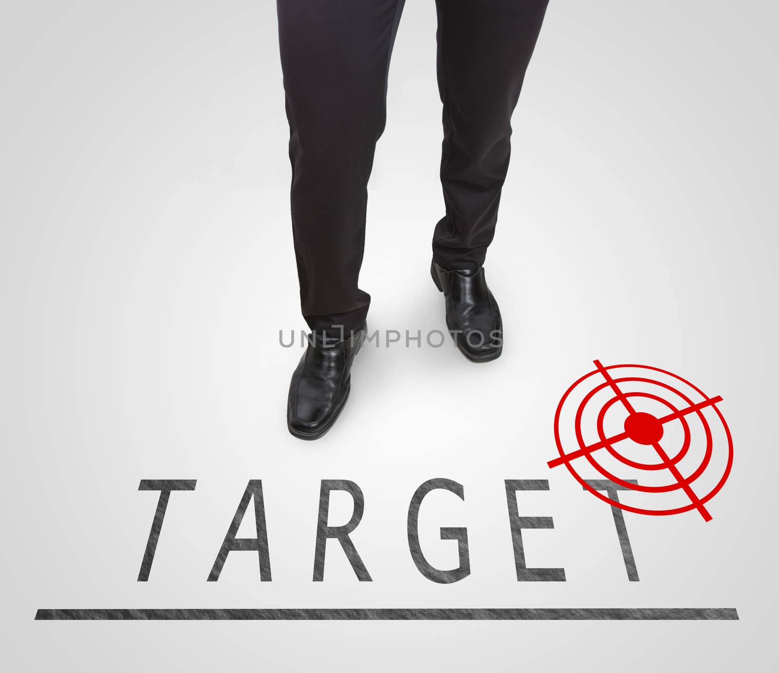 Businessman standing wearing court shoes on target(aim) line. by jayzynism