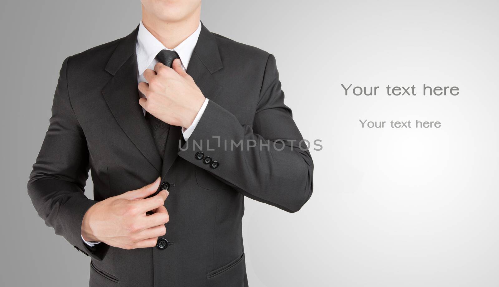 Well dressed businessman looklike smart adjusting  his neck tie  by jayzynism