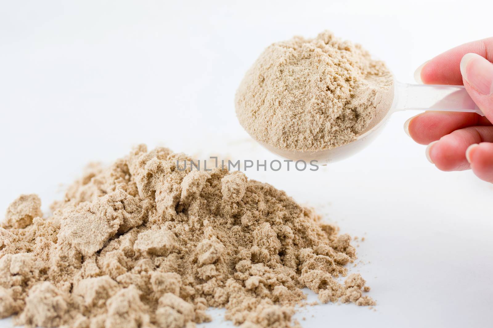 The hand raise a spoon measure Whey protein chocolate powder for by jayzynism