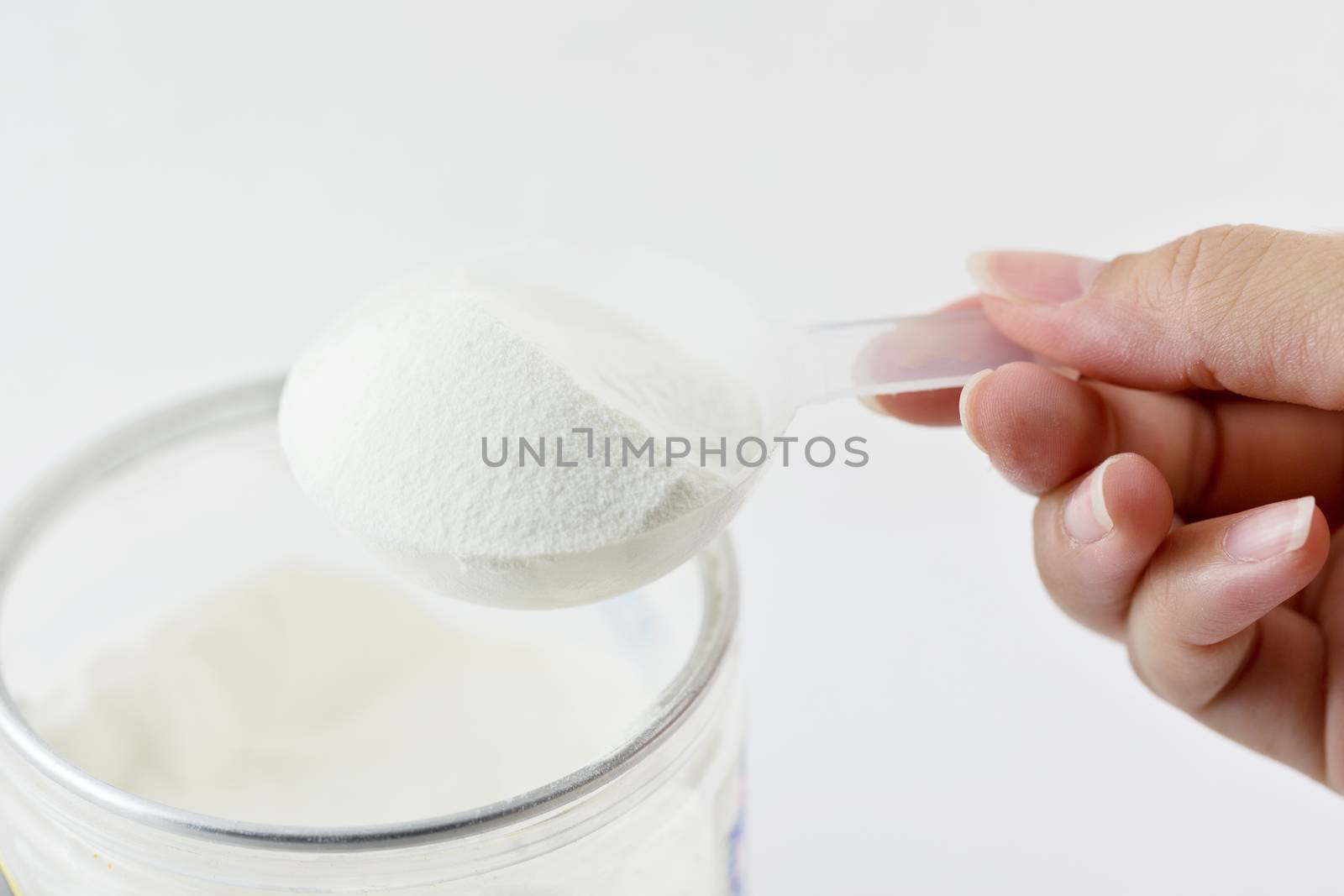 Collagen protein powder on spoon measure isolate on white background.