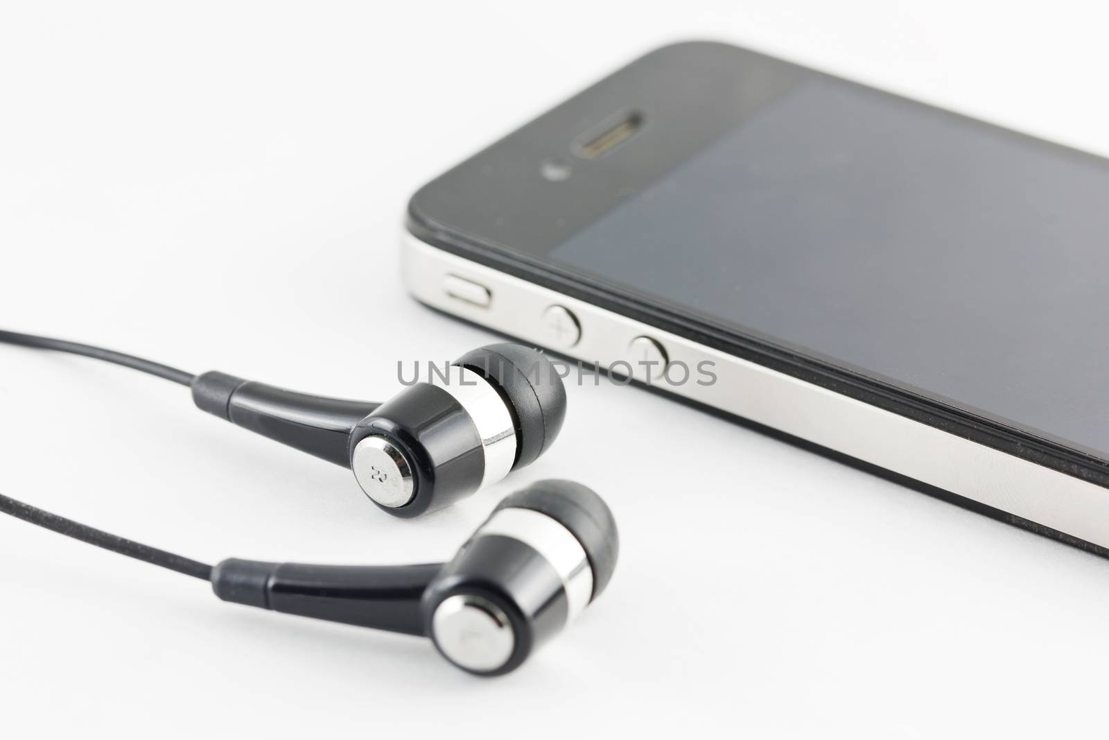 Black Earphone and Smartphone equipment set isolated on white ba by jayzynism