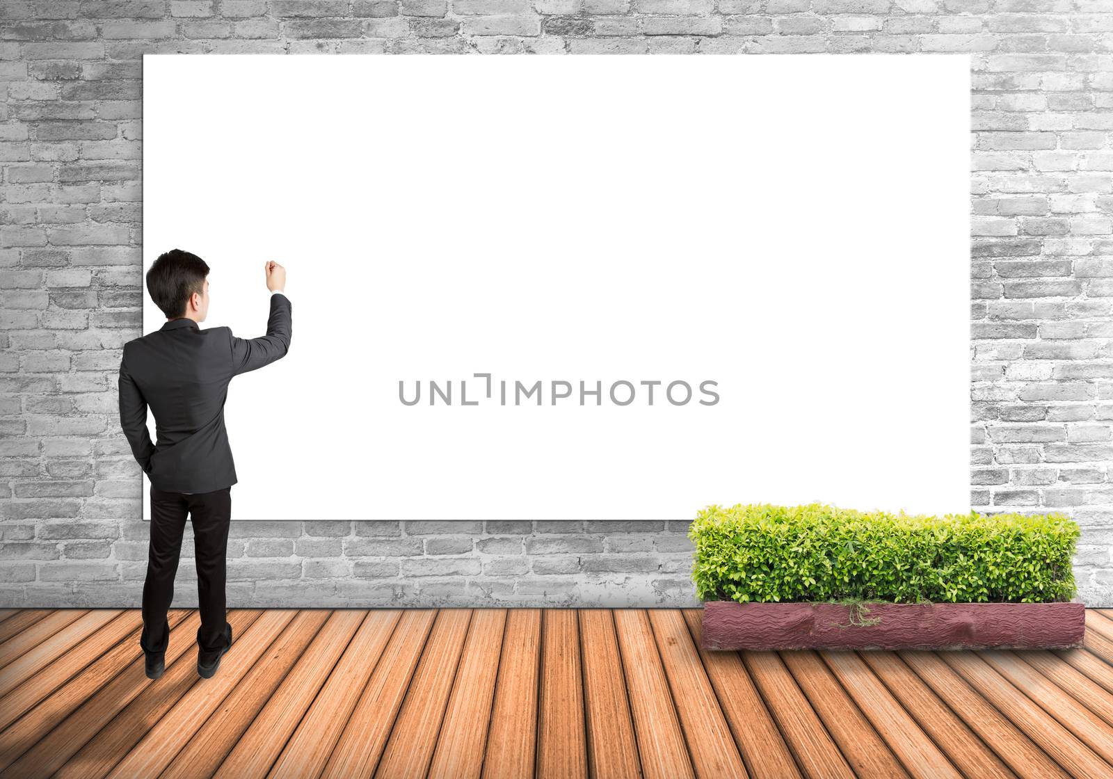 Businessman writing on white board imagine the future, isolated on wall background.