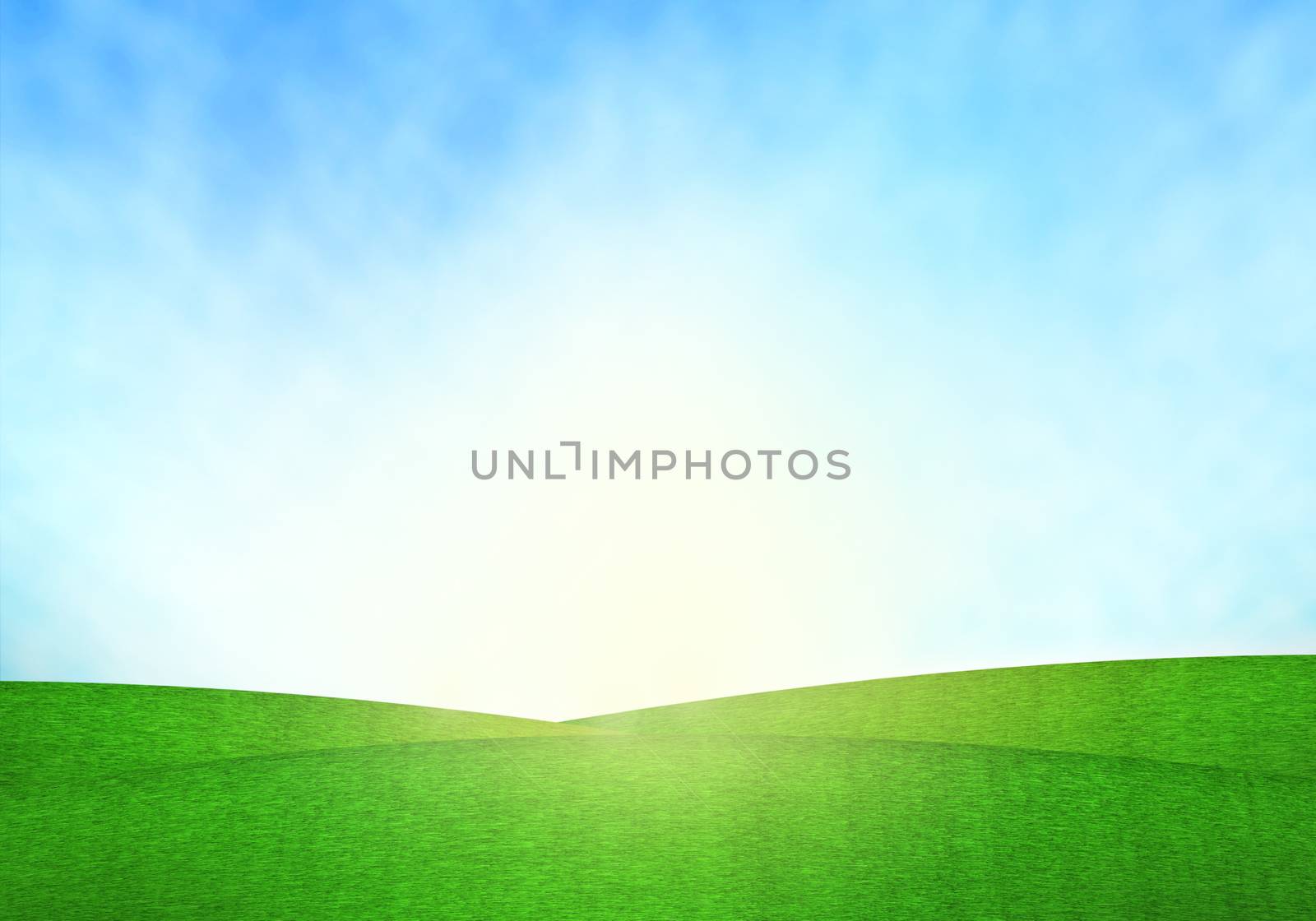 Green field, blue sky and lighting flare on grass.