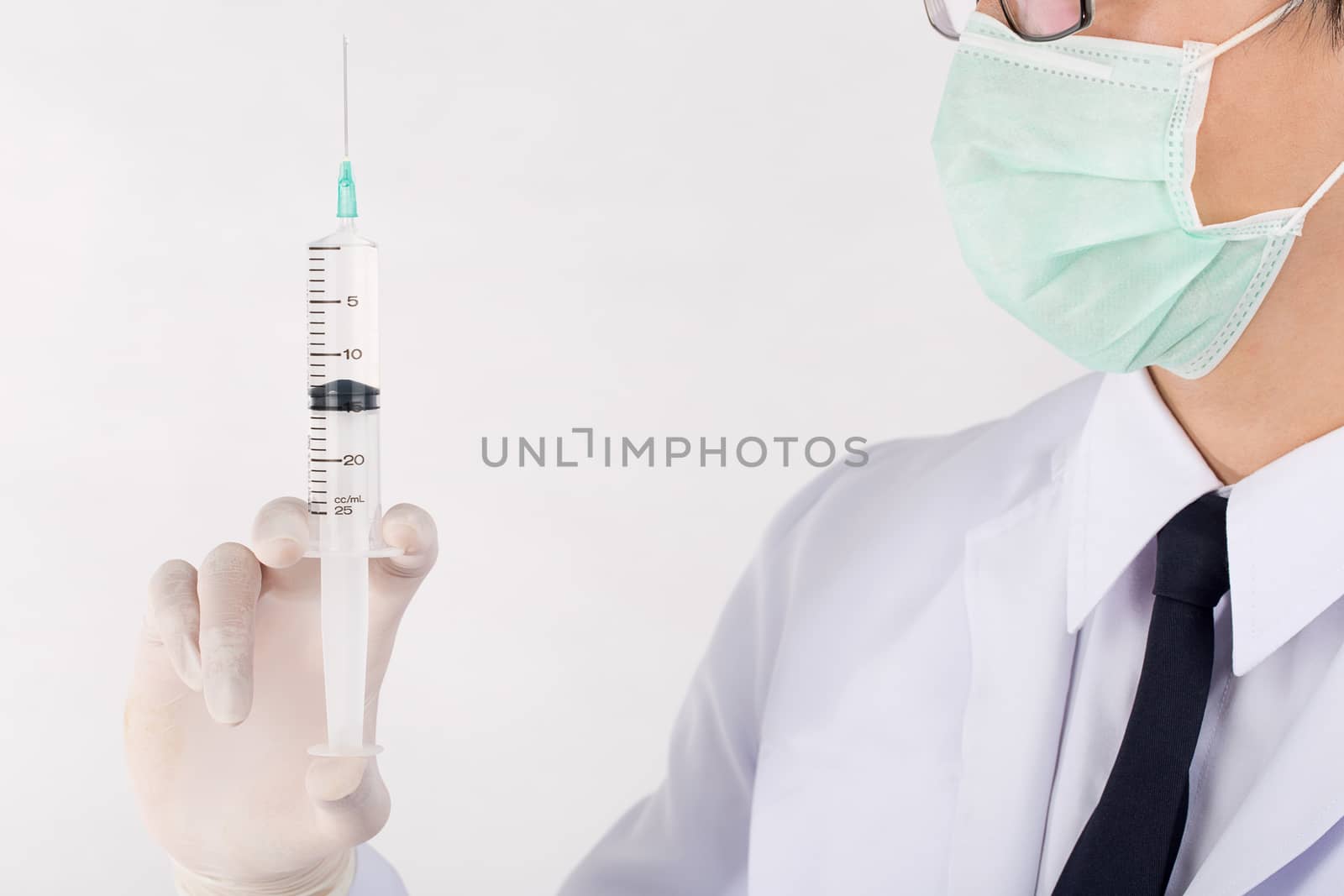 Doctor holding medical injection syringe with saline solution.