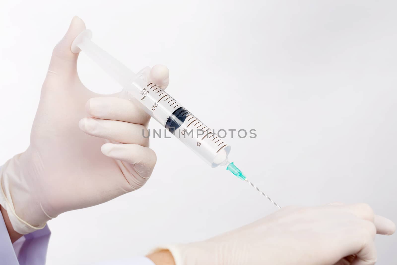 Doctor demonstrate inject saline solution patient isolated on wh by jayzynism