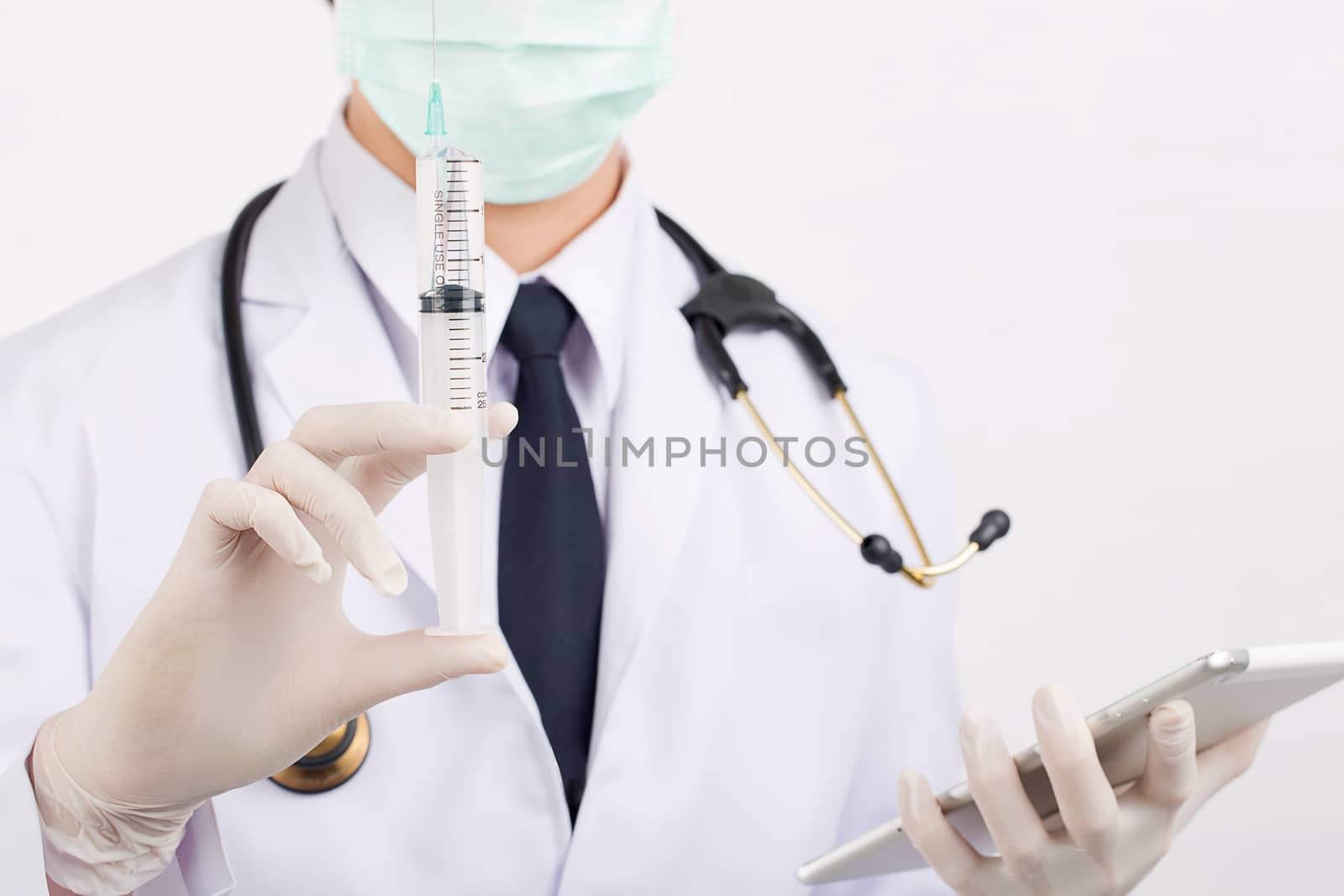 Doctor prepare equipment demonstrate: syringe and stethoscope. by jayzynism