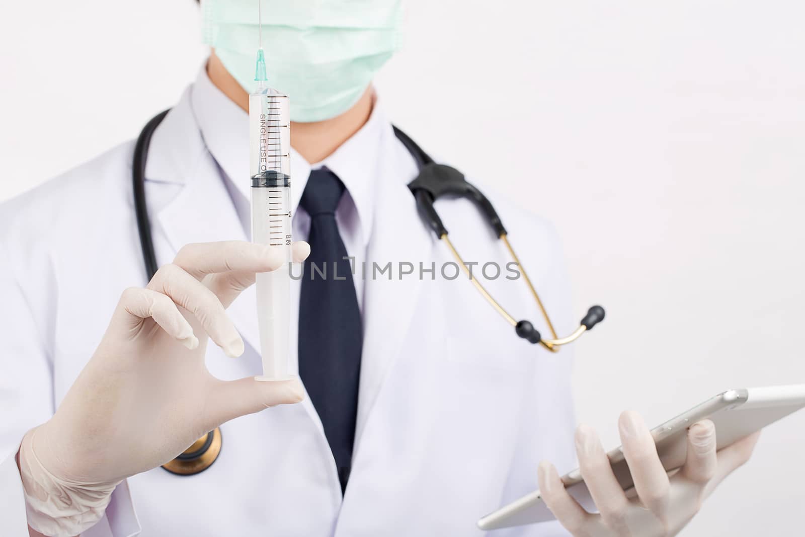 Doctor prepare equipment demonstrate: syringe and stethoscope.