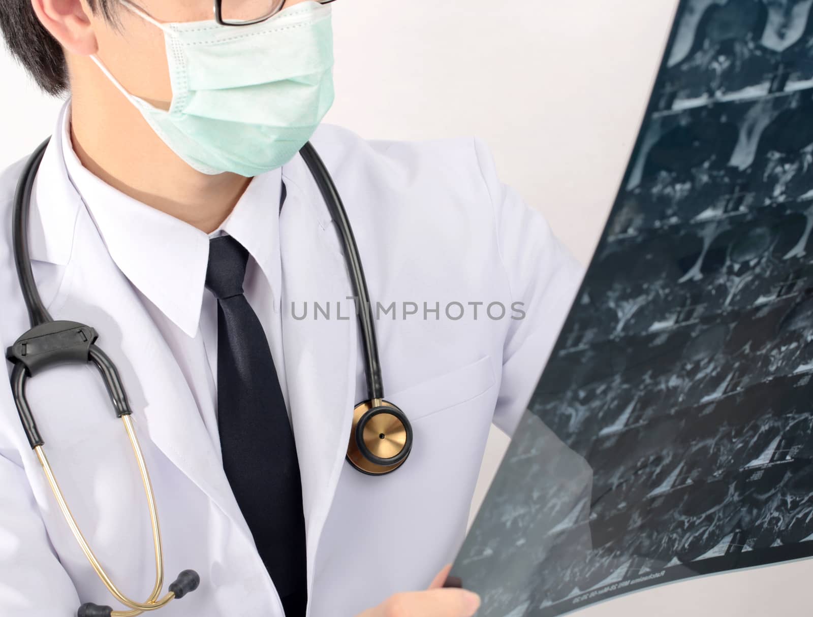 Close-up doctor holding and checking X-ray. by jayzynism