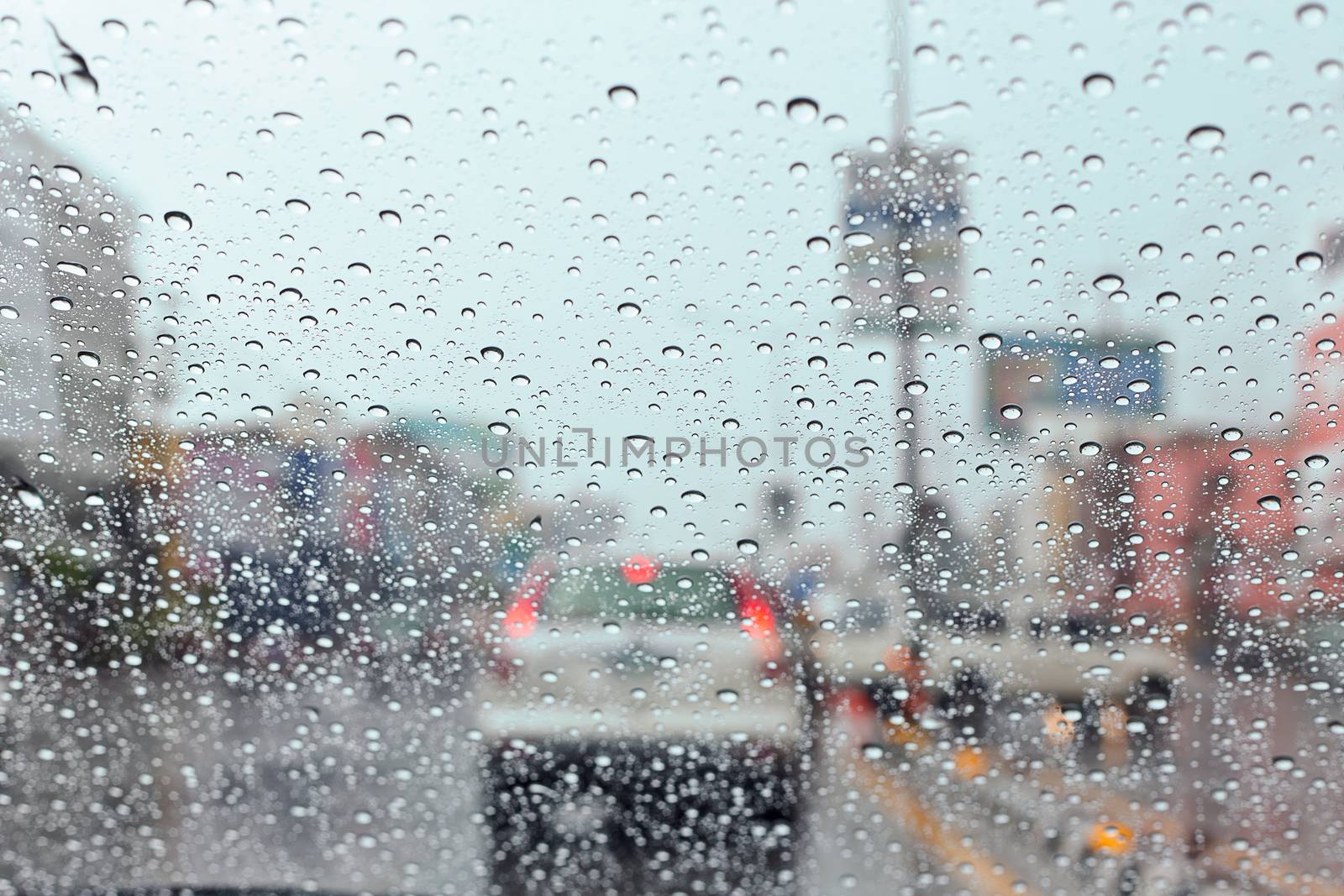 Water drop on traffic jam and electric light in the rain. by jayzynism
