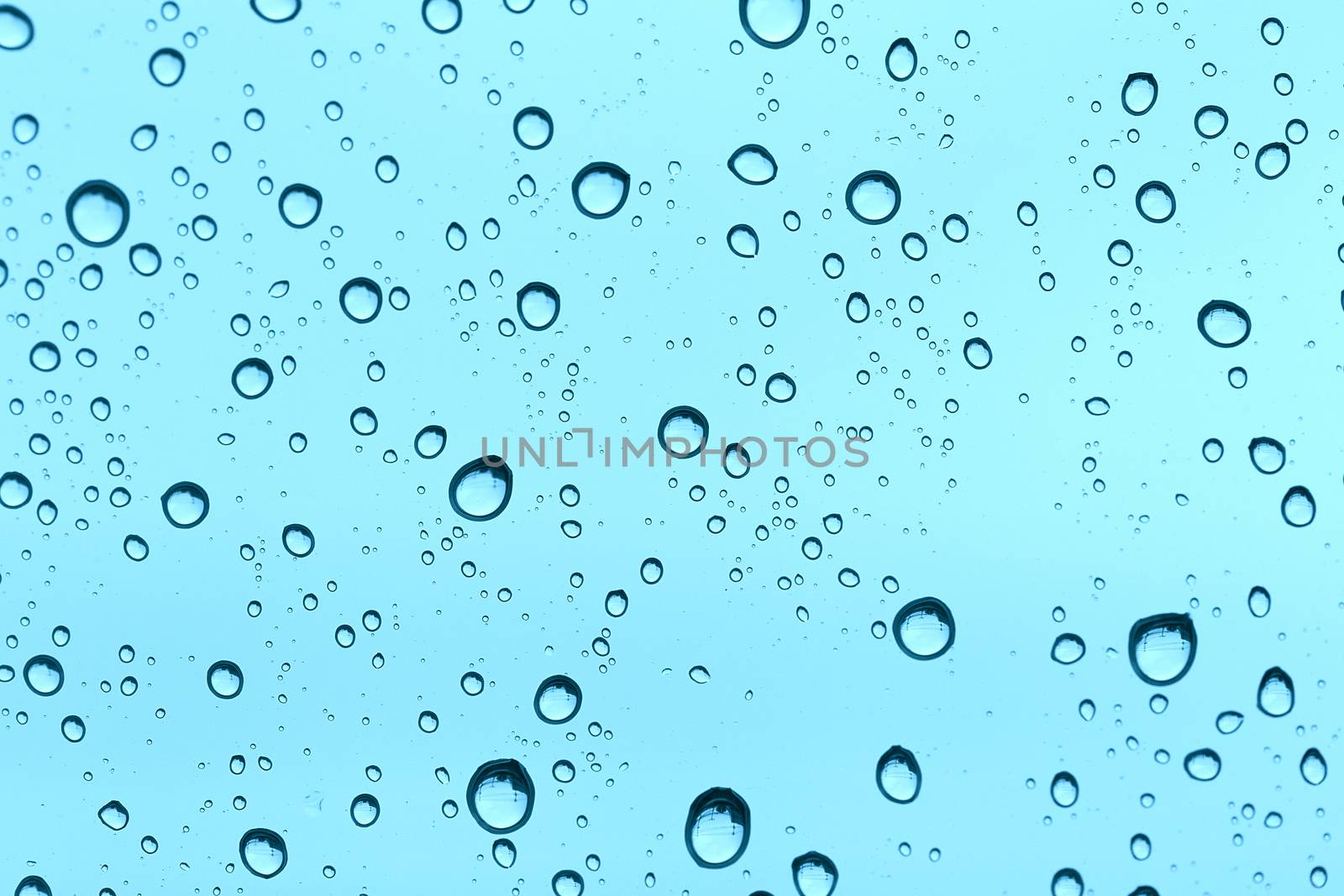 Water drop on glass mirror background. by jayzynism